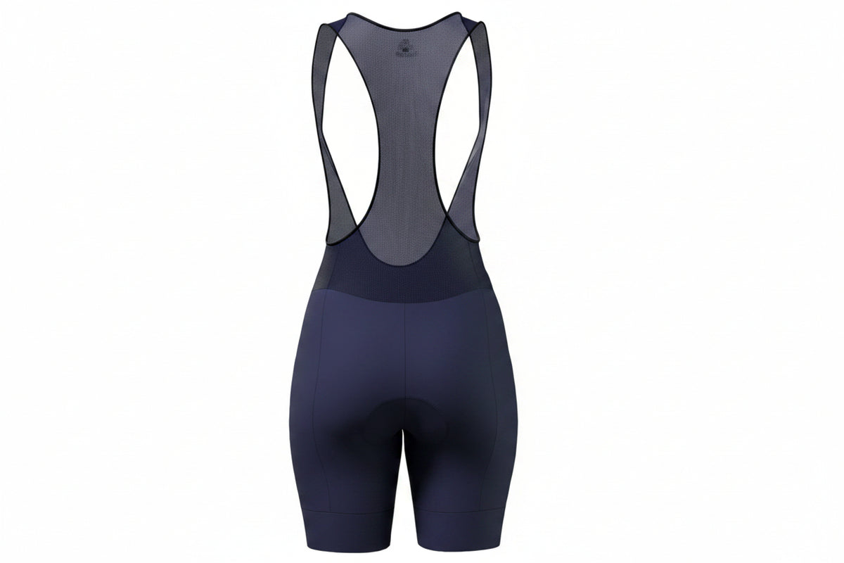 Licra corta de ciclismo azul oscuro para mujer vista trasera con corte en media luna para moldear la cola de A Guapa Bike.